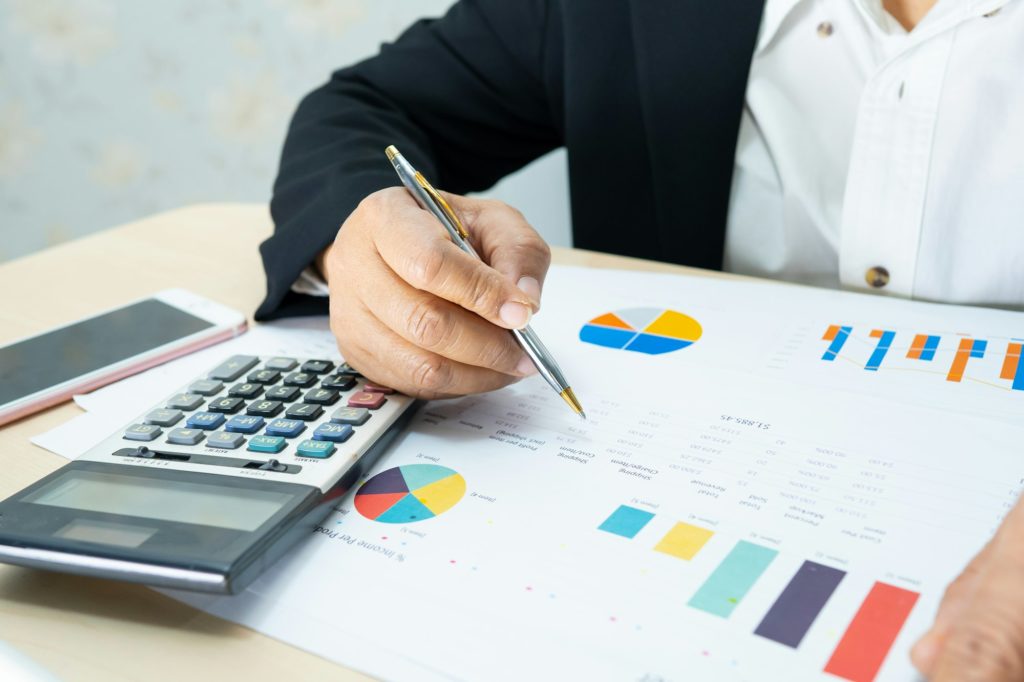 Asian accountant working and analyzing financial reports project accounting