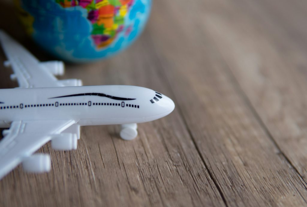 Closeup image of toy plane and earth globe on table with copy space.