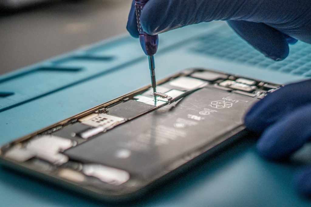 Closeup shot of a specialist repairing a mobile phone