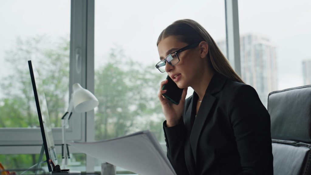 Concerned businesswoman speaking mobile phone closeup. Office manager working