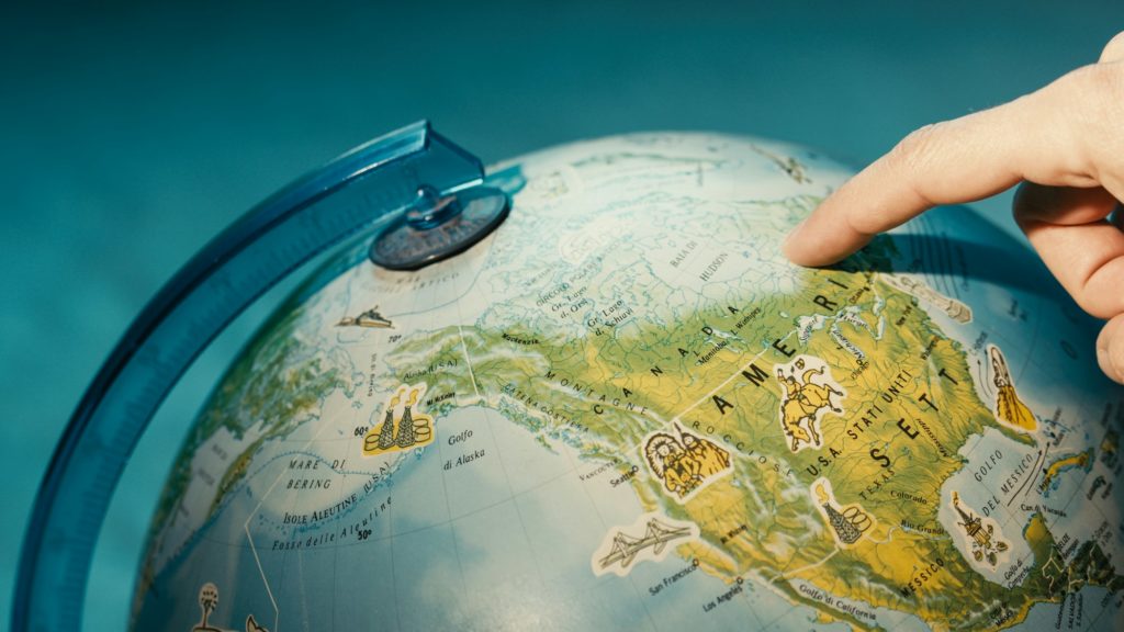 Finger pointing on globe