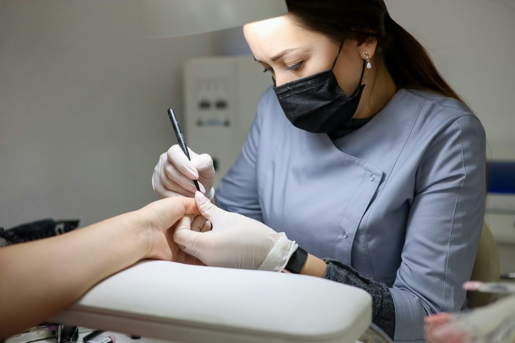 Girl manicure master does nail manicure.
