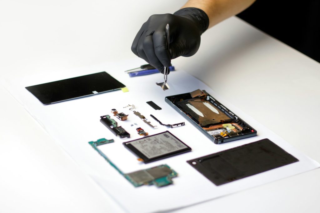 Repairman. Defocus technician repairing the smartphone's motherboard in the lab. Mobile phone, elect
